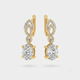 A pair of gold drop earrings featuring large oval clear gemstones in prong settings, with smaller pavé-set stones above in an openwork leaf-like design, shown on a light gray background.
